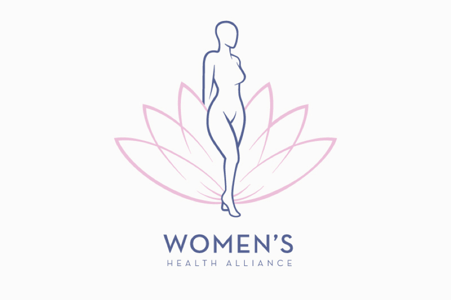 An outlined female form is centered within a pink lotus shaped form. The words Women's Health Alliance appear below in a modern purple sans serif font.